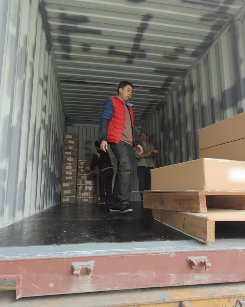 Workers loading cartons into a container