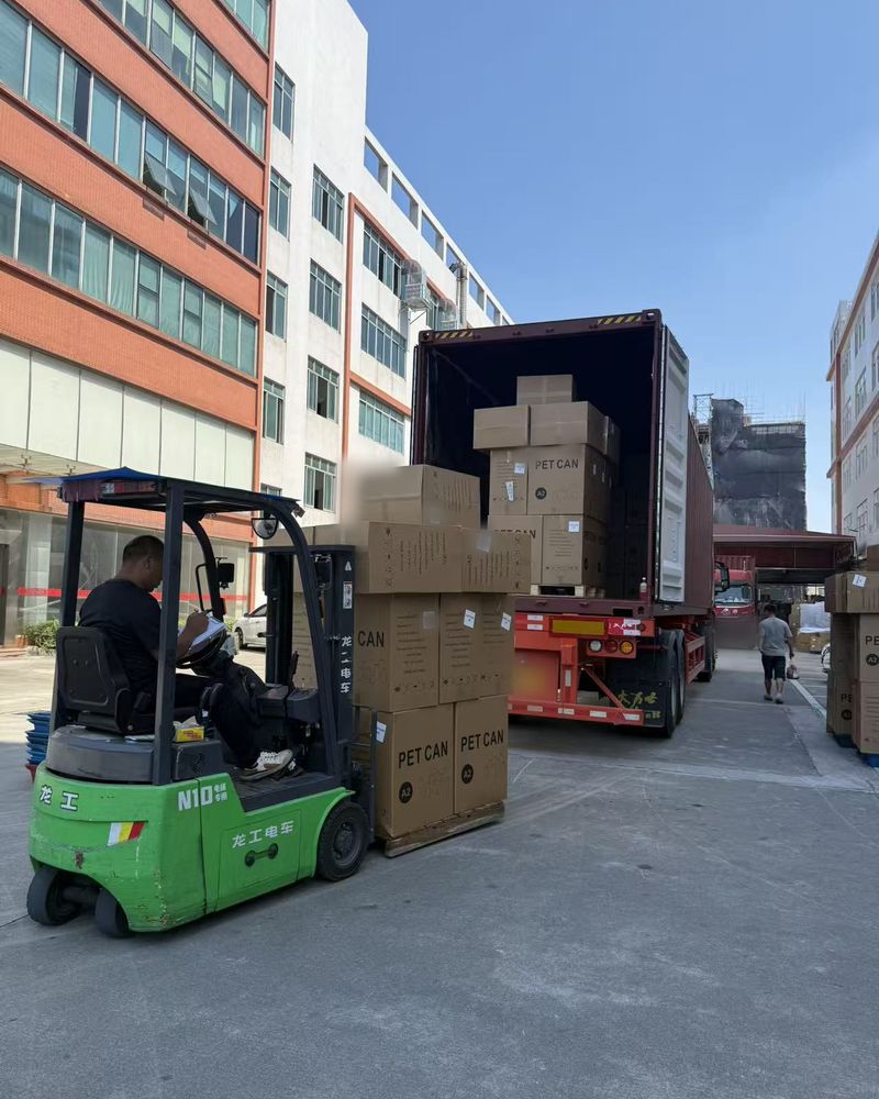 Forklift bringing PET can cartons to a container truck
